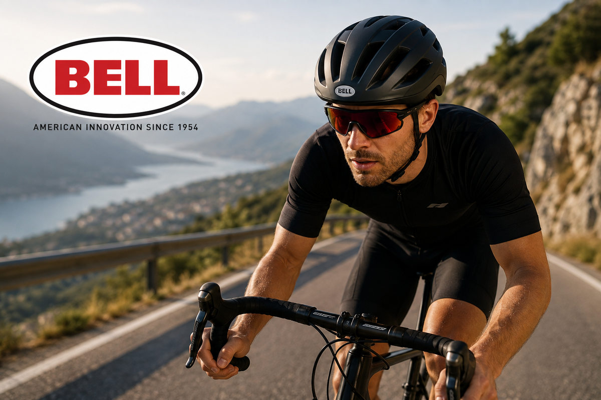 Landevejscyklist iført sort Bell cykelhjelm på en bjergvej med Bell-logo og teksten American Innovation Since 1954.